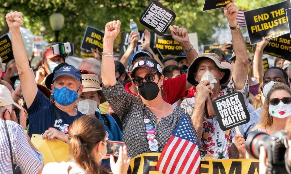 People participate in a rally to support voting rights at the Texas state capitol on 31 July