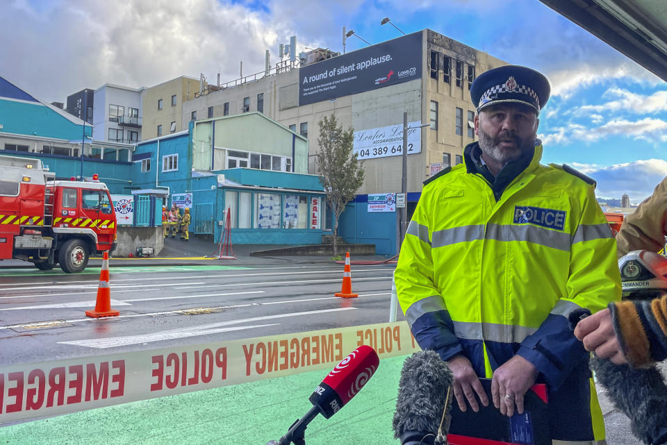 New Zealand Police Wellington Area Commander Inspector Dean Silvester speaks to the media outside Loafers Lodge hostel in central Wellington, New Zealand, Tuesday, May 16, 2023. Several people were killed after a fire broke out overnight at the four-story building. (Ben McKay/AAP Image via AP)