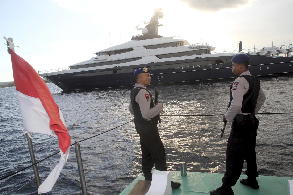 Indonesian police officers stand guard with the luxury yacht Equanimity in the background off Bali in February 2018. (File photo: AP /Yoan Ari)