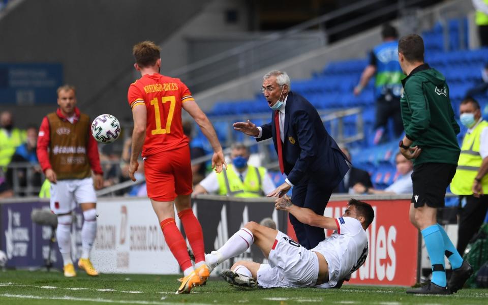 Edoardo Reja Head Coach of Albania is knocked to the ground by Rey Manaj of Albania during the International Friendly Match between Wales and Albania at the Cardiff City Stadium on June 5, 2021 in Cardiff, Wales. - GETTY IMAGES