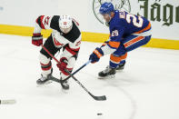 New York Islanders' Brock Nelson (29) fights for control of the puck with New Jersey Devils' Ryan Murray (22) during the second period of an NHL hockey game Saturday, May 8, 2021, in Uniondale, N.Y. (AP Photo/Frank Franklin II)