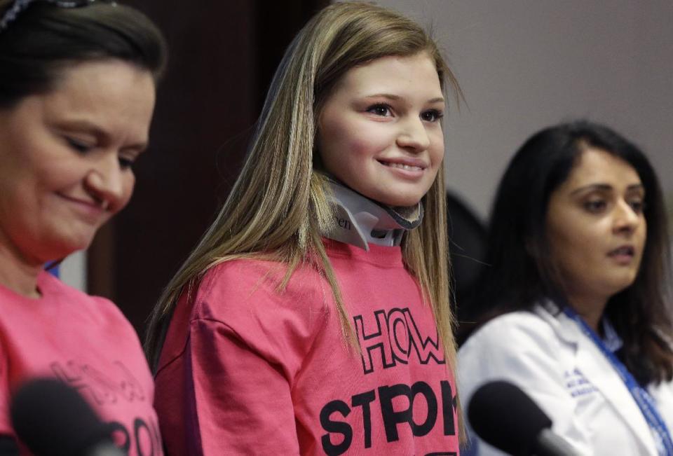 Makenzie Wethington, center, smiles during at a news conference with Dr. Seema R. Sikka, right, and her mother Holly Wethington at Baylor University Medical Center Thursday, Feb. 13, 2014, in Dallas. Wethington spoke for the first time publicly since she survived a fall of more than 3,000 feet in a skydiving accident in Oklahoma. Her doctor has said she's walking with assistance and is expected to recover. Her injuries included damage to her liver and a broken pelvis, lumbar spine in her lower back, shoulder blade, several ribs and teeth. (AP Photo/LM Otero)