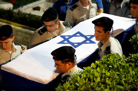 People carry the coffin of Zachary Baumel, a U.S.-born Israeli soldier missing since a 1982 tank battle against Syrian forces and whose remains were recently recovered by Israel, during his funeral at the Mount Herzl military cemetery in Jerusalem April 4, 2019. REUTERS/Ronen Zvulun