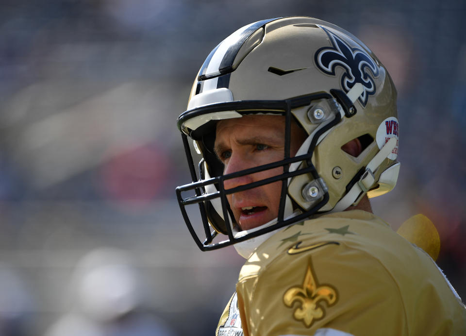 Drew Brees looks ahead during warmups for the Pro Bowl while wearing a gold Saints helmet and jersey.