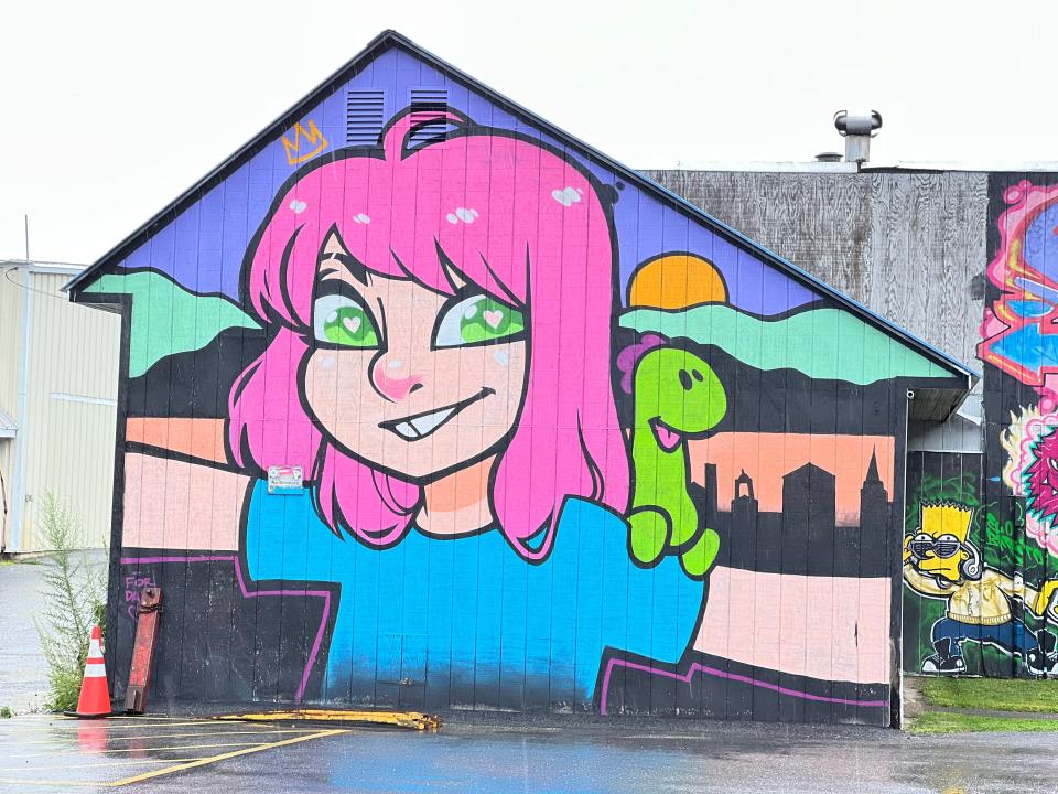 A building near the marina on King St. includes this starry-eyed, pink haired character with a "Champ" on their shoulder, as seen on Aug. 3, 2023.