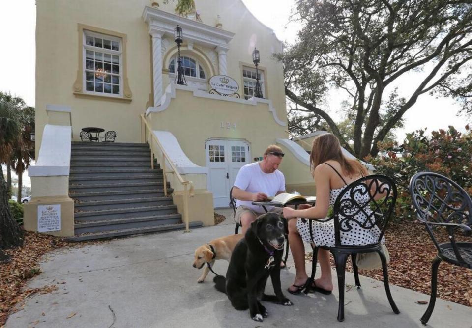 Mary Teske and Matt Hudson of Minneapolis, MN., and their dogs, Dixie and Chip, sit outside Le Cafe Beignet on Monday, March 5, 2018, as they explore South Mississippi.