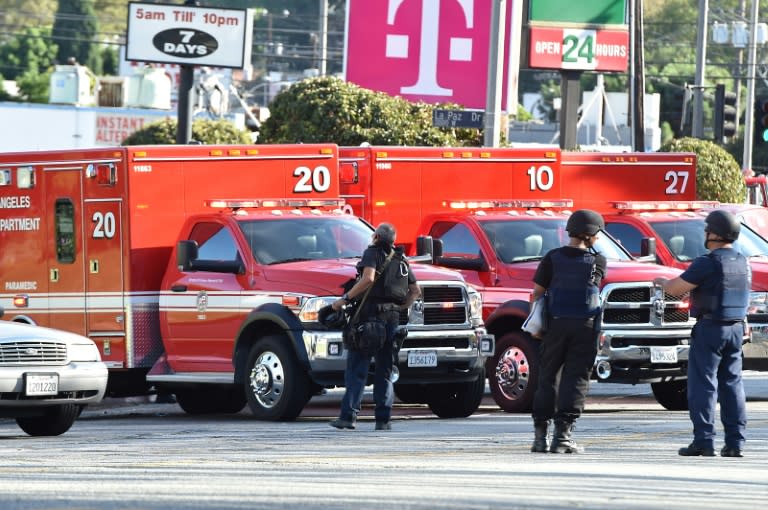 Police officers and members of the Los Angeles Fire Department on the scene of the incident, in which a woman was shot dead