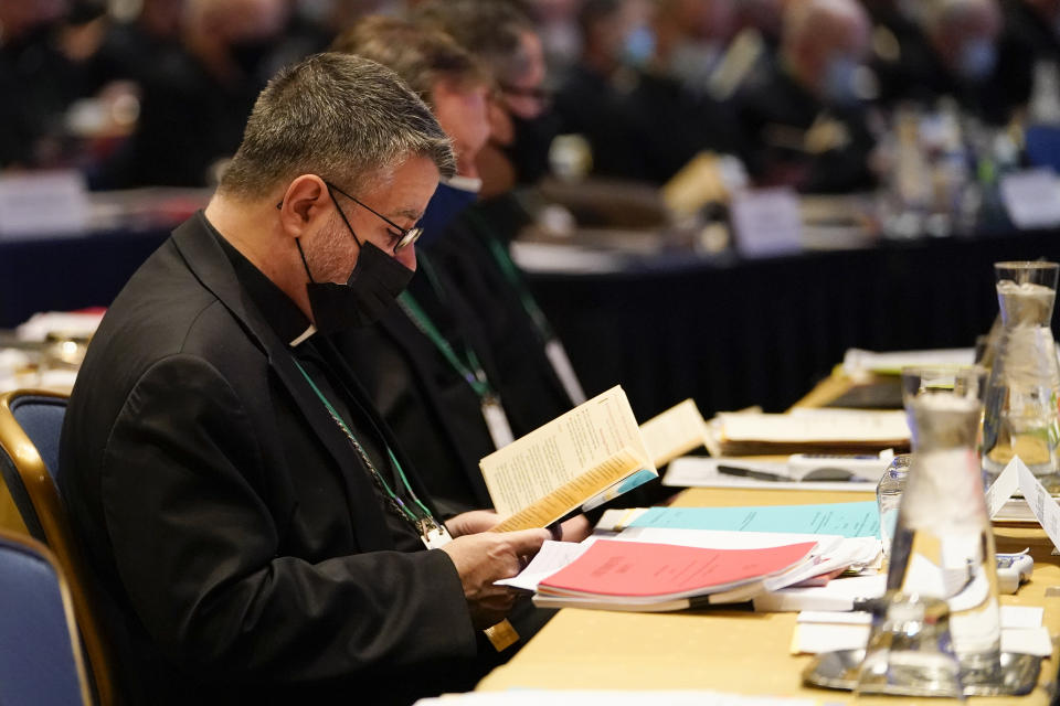 Bishop Elias Lorenzo, of he Roman Catholic Archdiocese of Newark, N.J., reads scripture during a morning prayer at the Fall General Assembly meeting of the United States Conference of Catholic Bishops, Wednesday, Nov. 17, 2021, in Baltimore.(AP Photo/Julio Cortez)
