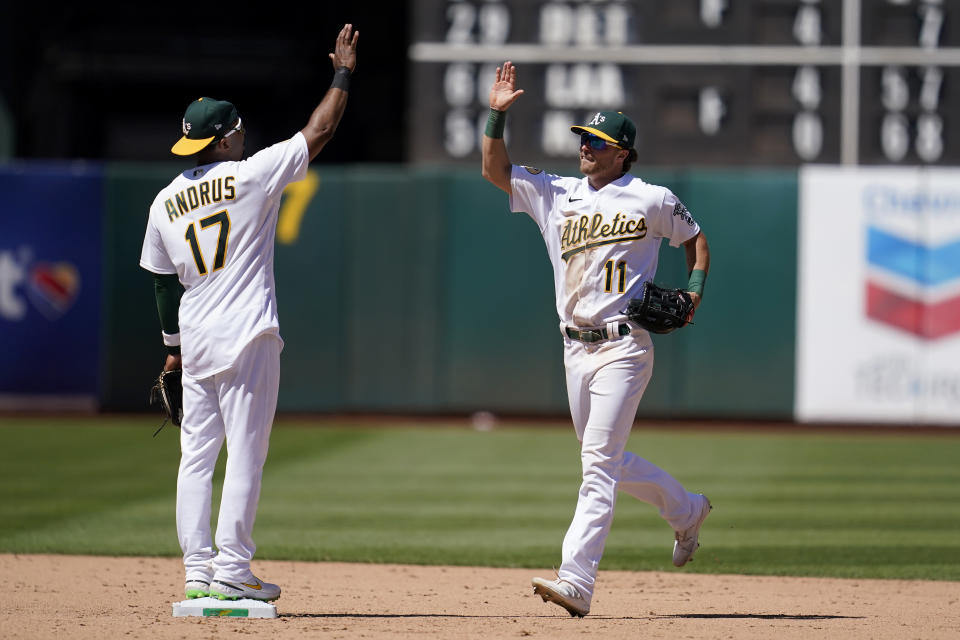 Oakland Athletics' Elvis Andrus, left, celebrates with Skye Bolt after the Athletics defeated the Houston Astros in a baseball game in Oakland, Calif., Wednesday, July 27, 2022. (AP Photo/Jeff Chiu)