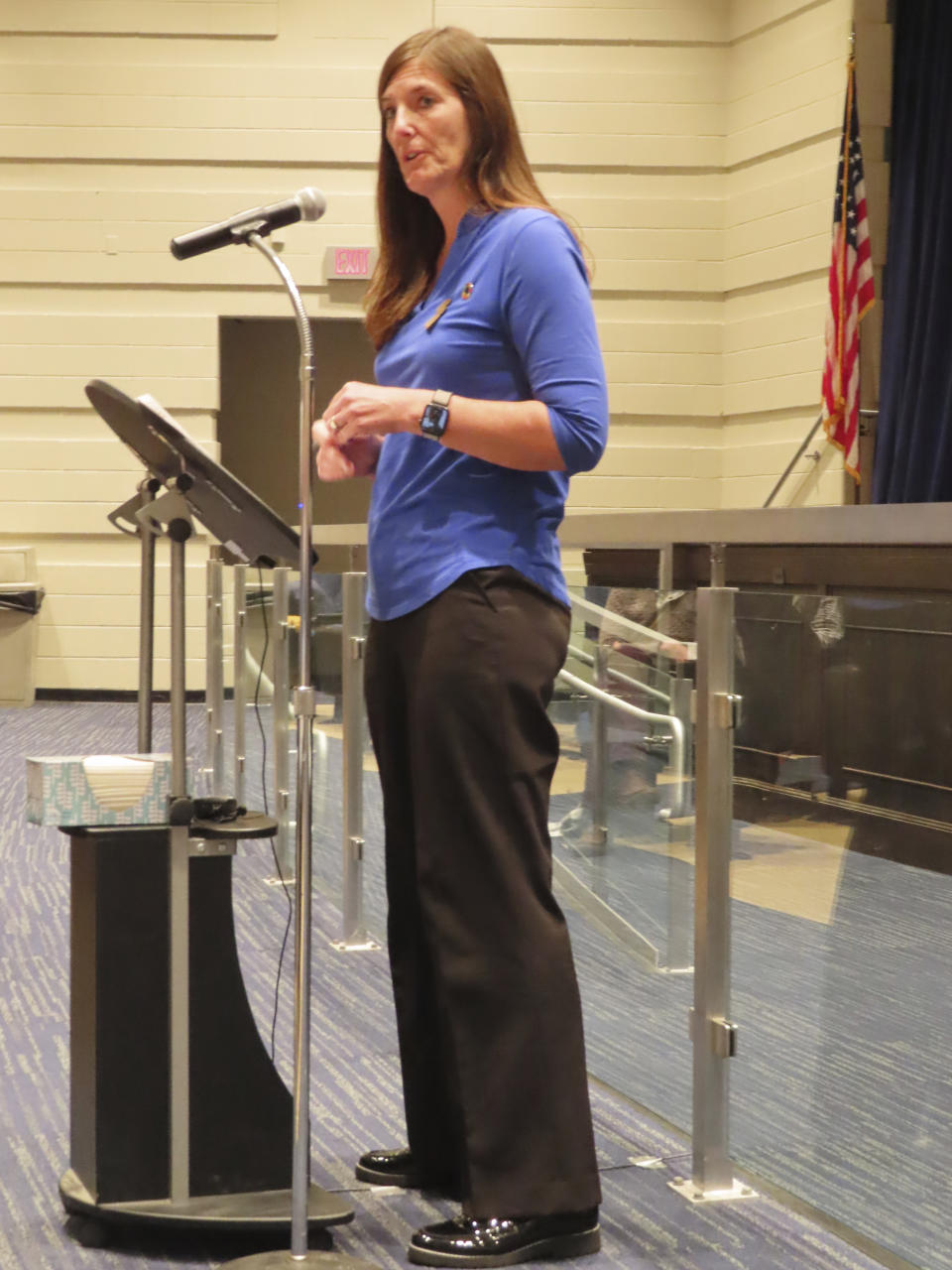 Christine Girtain, a science teacher in one of Toms River, N.J.'s high schools, speaks at a public meeting in Toms River on Wednesday, Jan., 25, 2023, about a proposed settlement between the New Jersey Department of Environmental Protection and BASF Corp to restore natural resources that were damaged by the operations of the former Ciba Geigy chemical plant. Girtain wants an environmental education center that will be built as part of the settlement to document the site's history of illegal dumping and the town's history of elevated childhood cancer cases and deaths. (AP Photo/Wayne Parry)