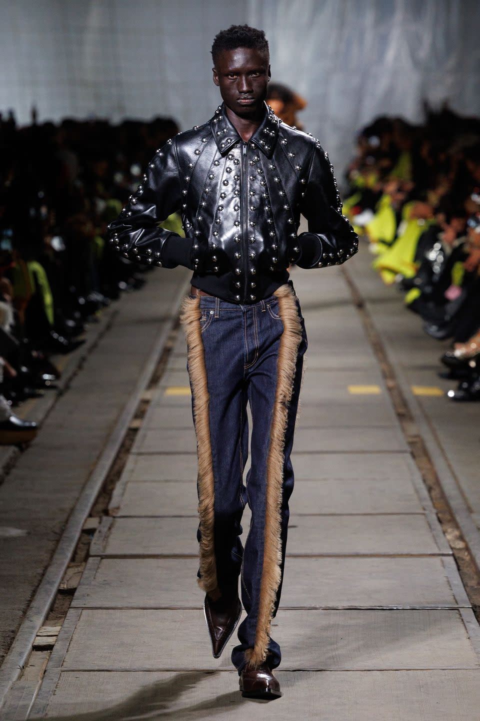 a man walking on a runway