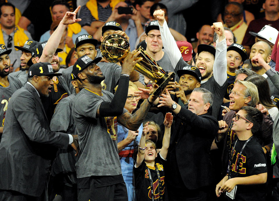 Jun 19, 2016; Oakland, CA, USA; Cleveland Cavaliers forward LeBron James (23) celebratew with the Larry O'Brien Championship Trophy after beating the Golden State Warriors in game seven of the NBA Finals at Oracle Arena. Mandatory Credit: Gary A. Vasquez-USA TODAY Sports