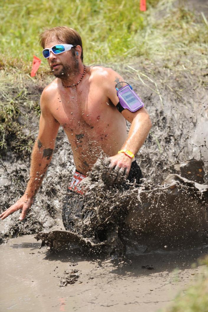 This Saturday, April 27, 2013 photo provided by Nuvision Action Image LLC shows a contestant in The Mud Monster competing during The Survival Race in Dallas. (AP Photo/Nuvision Action Image LLC)