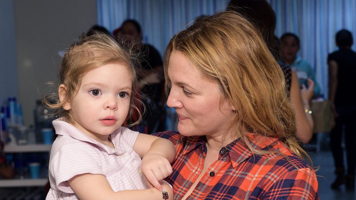 Drew Barrymore and daughter attend Baby2Baby Holiday Party Presented By The Honest Company at Baby2Baby Headquarters on December 13, 2014 in Los Angeles, California