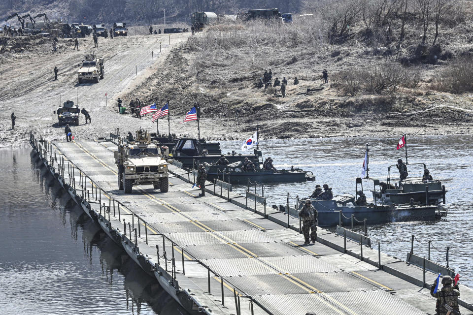 In this photo provided by the South Korea Defense Ministry, South Korea and U.S. militaries conduct a joint river-crossing drill in Yeoncheon, South Korea, Monday, March 13, 2023. South Korea’s president wants Japan to join his efforts to improve ties frayed over Tokyo’s past colonial rule, saying there is an increasing need for greater bilateral cooperation because of North Korean nuclear threats and global supply chain challenges. (South Korea Defense Ministry via AP)