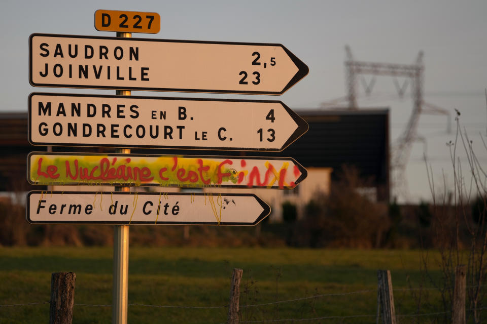 A road sign is painted with "Nuclear Is Over" next to an underground laboratory in Bure, eastern France, Thursday, Oct. 28, 2021. Nuclear power is a central sticking point as negotiators plot out the world’s future energy strategy at the climate talks in Glasgow, Scotland. (AP Photo/Francois Mori)