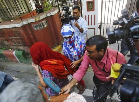 Two veiled Nepali women, who told police they were raped by a Saudi official, walk outside Nepal's embassy in New Delhi, India, September 9, 2015. REUTERS/Anindito Mukherjee