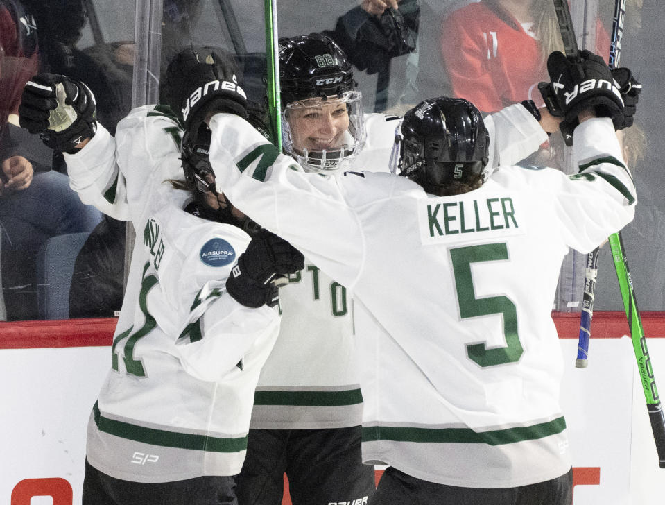 Boston's Susanna Tapani, centre, celebrates her goal over Montreal with teammates Megan Keller (5) and Alina Muller (11) during overtime of Game 1 of a PWHL hockey playoff series, Thursday, May 9, 2024, in Montreal. (Christinne Muschi/The Canadian Press via AP)