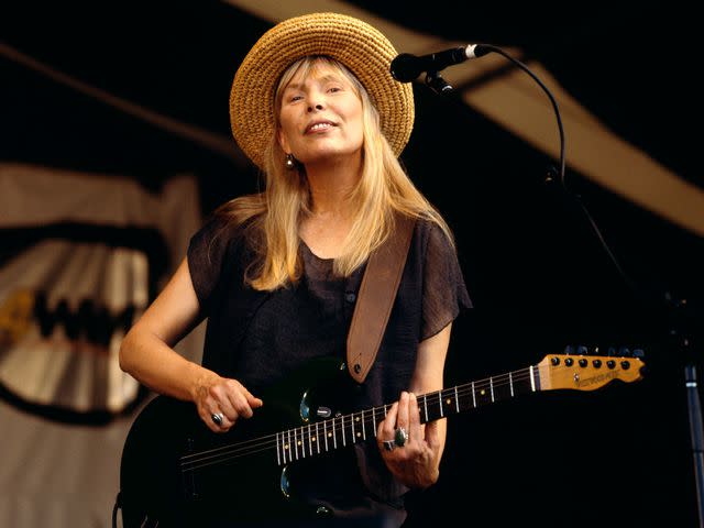 <p>David Redfern/Redferns</p> Joni Mitchell performing on stage at the New Orleans Jazz Festival.