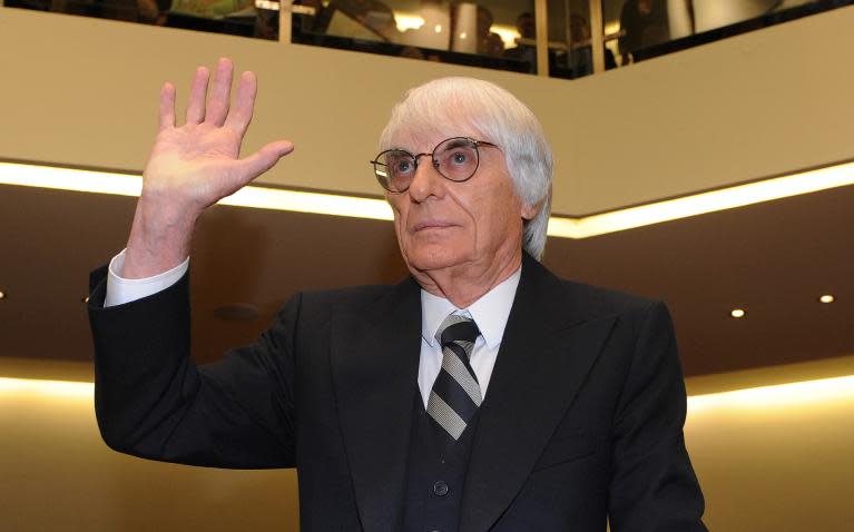 A photo taken on November 9, 2011 showing Bernie Ecclestone waving as he arrives at the courtroom in Munich, southern Germany