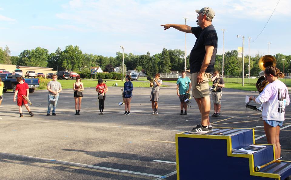 Hillsdale High School band director Keith Rushing preparing students for the half-time show.