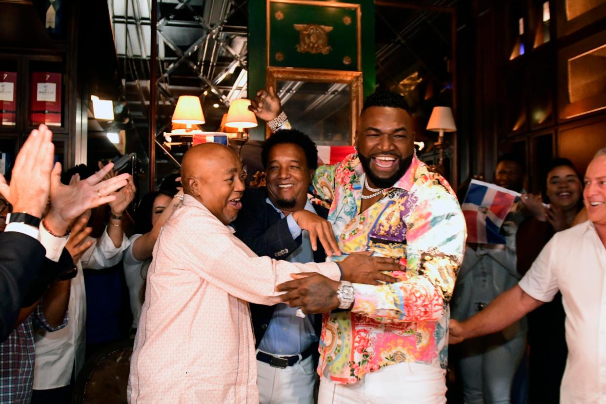 Former Boston Red Sox player David Ortiz celebrates his election to the baseball hall of fame with his father Leo Ortiz, left, MLB Hall of Fame Pedro Martinez, center, and Fernando Cuzza, right, moments after receiving the news in Santo Domingo, Dominican Republic on Tuesday.