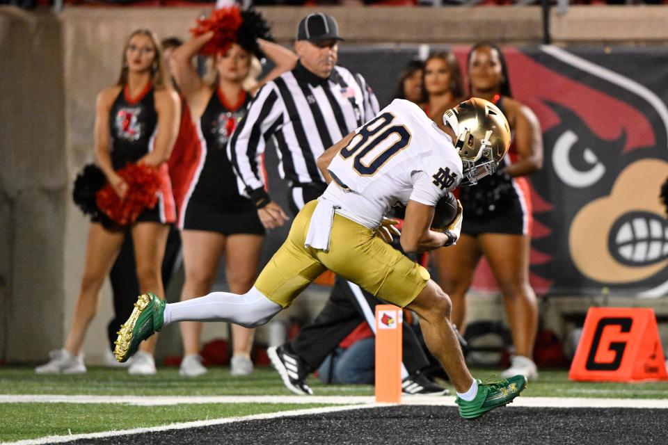 Oct 7, 2023; Louisville, Kentucky, USA; Notre Dame Fighting Irish wide receiver Jordan Faison (80) runs the ball in for a touchdown against the Louisville Cardinals during the first half at L&N Federal Credit Union Stadium. Mandatory Credit: Jamie Rhodes-USA TODAY Sports