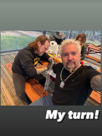 <p>Guy Fieri/Instagram</p> Guy Fieri shares a photo of himself getting tatted