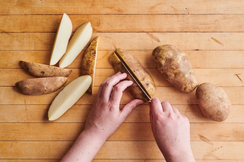 someone is slicing potatoes