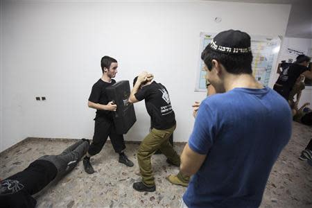Ultra-Orthodox Jewish youths take part in an Israeli martial arts training lesson in Mevasseret Zion, near Jerusalem, October 14, 2013. REUTERS/Baz Ratner
