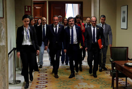 Jailed Catalan politicians Josep Rull, Jordi Sanchez and Jordi Turull leave after getting their parliamentary credentials at Spanish Parliament, in Madrid, Spain, May 20, 2019. REUTERS/Susana Vera