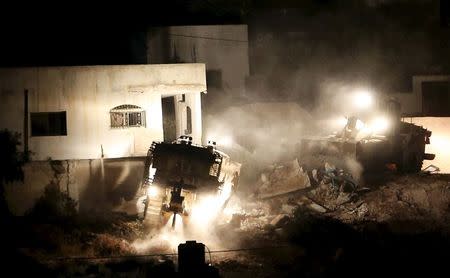 Israeli army machines demolish a Palestinian house during an Israeli raid in the West Bank city of Jenin September 1, 2015. REUTERS/Mohamad Torokman