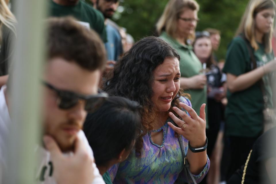 A student gets emotional as she comes to the steps of Kennedy Hall to lay a candle to honor the victims of a shooting the day earlier at the University of North Carolina Charlotte, in Charlotte, North Carolina on May 1, 2019.