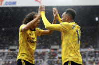 Arsenal's Pierre-Emerick Aubameyang, right, celebrates scoring his side's first goal of the game with team mate Matteo Guendouzi, during the English Premier League soccer match between Newcastle United and Arsenal, at St James' Park, in Newcastle, England, Sunday, Aug. 11, 2019. (Owen Humphreys/PA via AP)