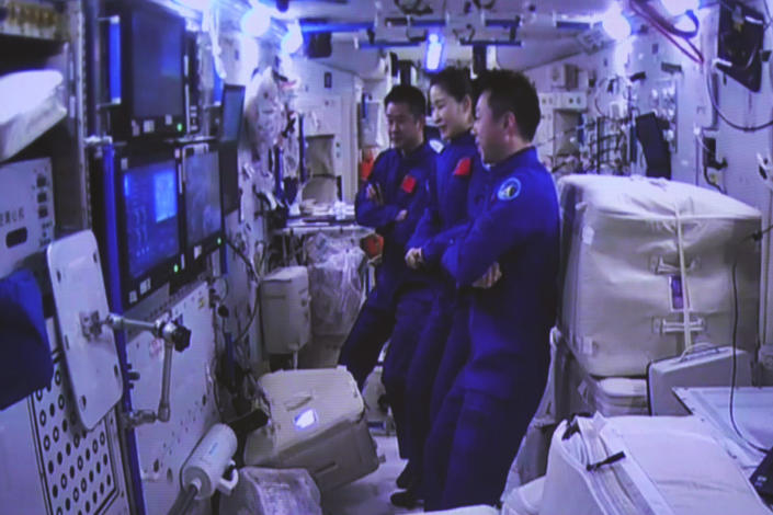 This photo released by Xinhua News Agency shows an image captured off the screen at the Jiuquan Satellite Launch Center in northwest China showing the crew of China's Shenzhou-14 manned spaceship observing the Shenzhou-15 spaceship conducting a fast automated rendezvous and docking with the space station's Tianhe module on Nov. 30, 2022. Three Chinese astronauts docked early Wednesday with their country's space station, where they will overlap for several days with the three-member crew already onboard and expand the facility to its maximum size. (Guo Zhongzheng/Xinhua via AP)