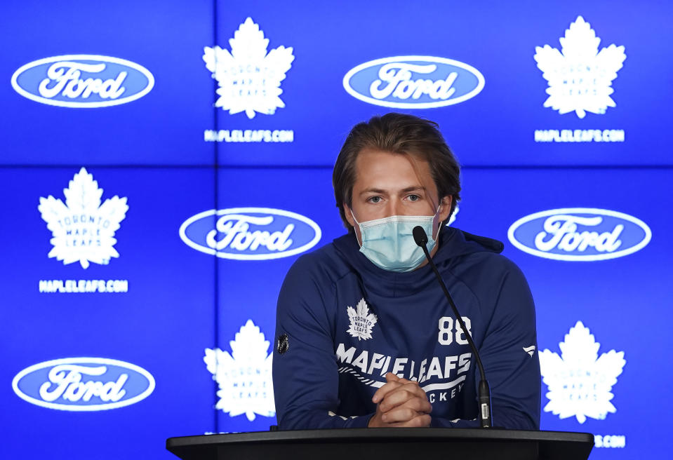 Toronto Maple Leafs forward William Nylander wears a protective mask as he speaks to the media at the NHL hockey team's training camp in Toronto, Wednesday, Sept. 22, 2021. (Nathan Denette/The Canadian Press via AP)