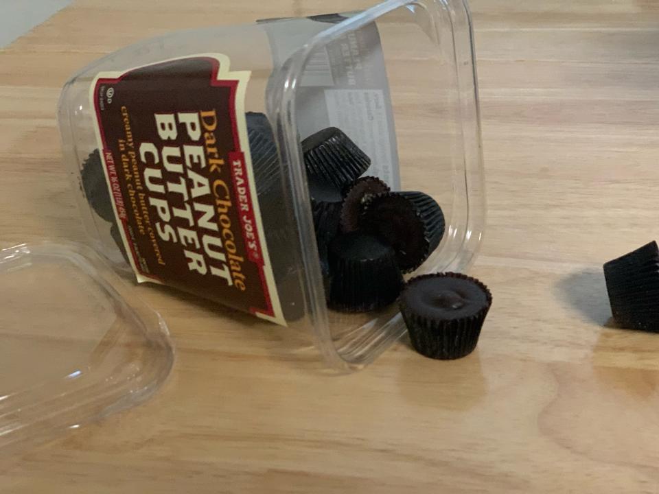 trader joe's chocolate peanut butter cups spilling onto wood table