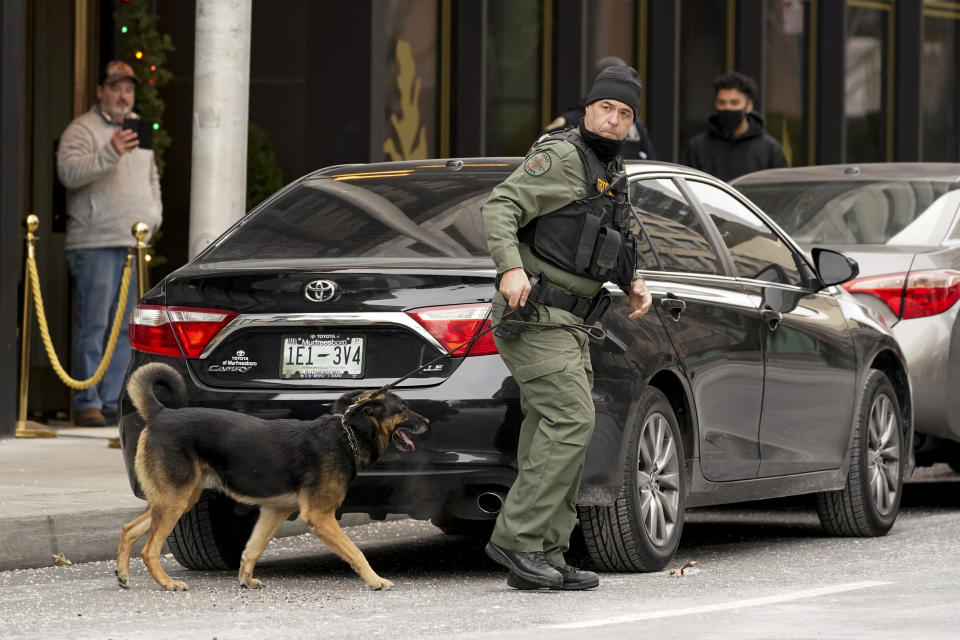 A K-9 team works in the area of an explosion in downtown Nashville, Tenn., Friday, Dec. 25, 2020. Buildings shook in the immediate area and beyond after a loud boom was heard early Christmas morning.(AP Photo/Mark Humphrey)