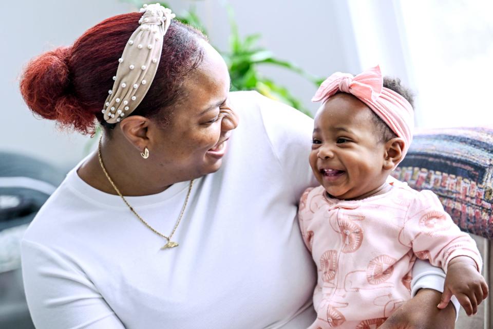 Chelena Bell, left, smiles with her daughter on Friday, March 22, 2024, at their home in Holt. Bell used a doula to assist with the births of her two youngest children.