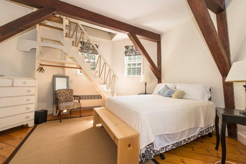 A charming bedroom is inside the converted windmill. Rise Media/Douglas Elliman