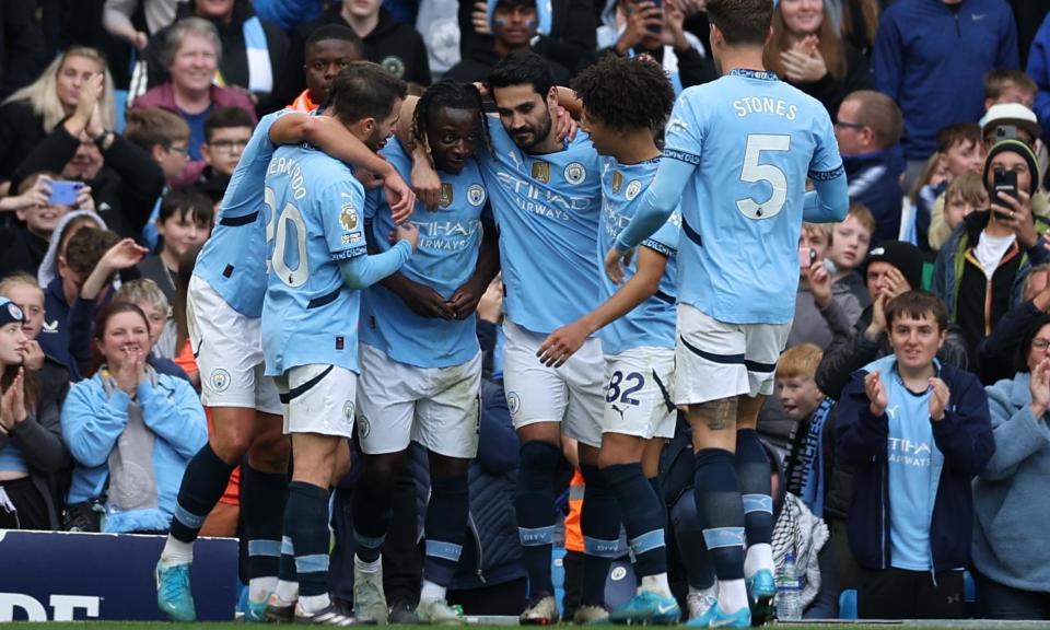 <span>Jérémy Doku is congratulated after scoring what proved the decisive goal for Manchester City against Fulham.</span><span>Photograph: Adam Vaughan/EPA</span>