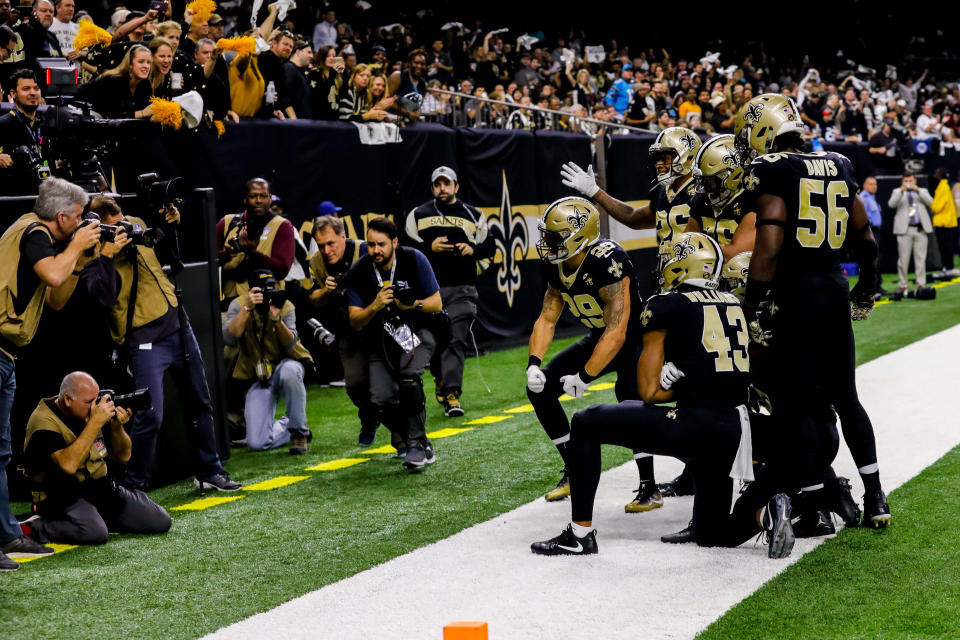 Demario Davis (56) and the Saints’ defense pose for the cameras after picking off a pass