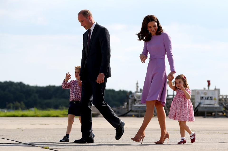 Britain's Prince William, Duke of Cambridge and his wife Kate, the Duchess of Cambridge, walk with  their children Prince George and Princess Charlotte to vivit Airbus helicopters on the tarmac of the Airbus compound in Hamburg, northern Germany, on July 21,2017.
 The British royal couple are on the last stage of their three-day visit to Germany. / AFP PHOTO / POOL / Christian Charisius        (Photo credit should read CHRISTIAN CHARISIUS/AFP/Getty Images)