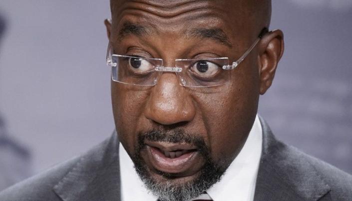 Sen. Raphael Warnock, D-Ga., speaks to reporters at the Capitol in Washington, July 26, 2022.