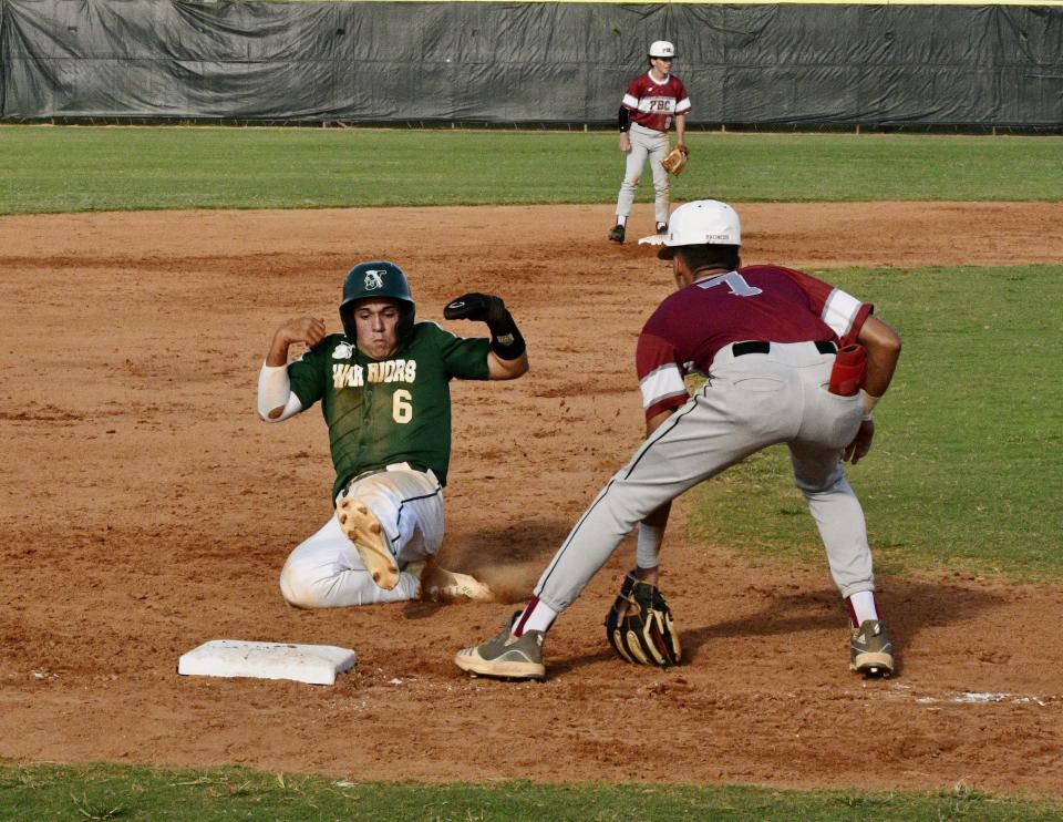 Jupiter's Mason Barela slides into third base following a hit by his teammate during Tuesday's regional quarterfinals loss to Palm Beach Central on May 10, 2022.