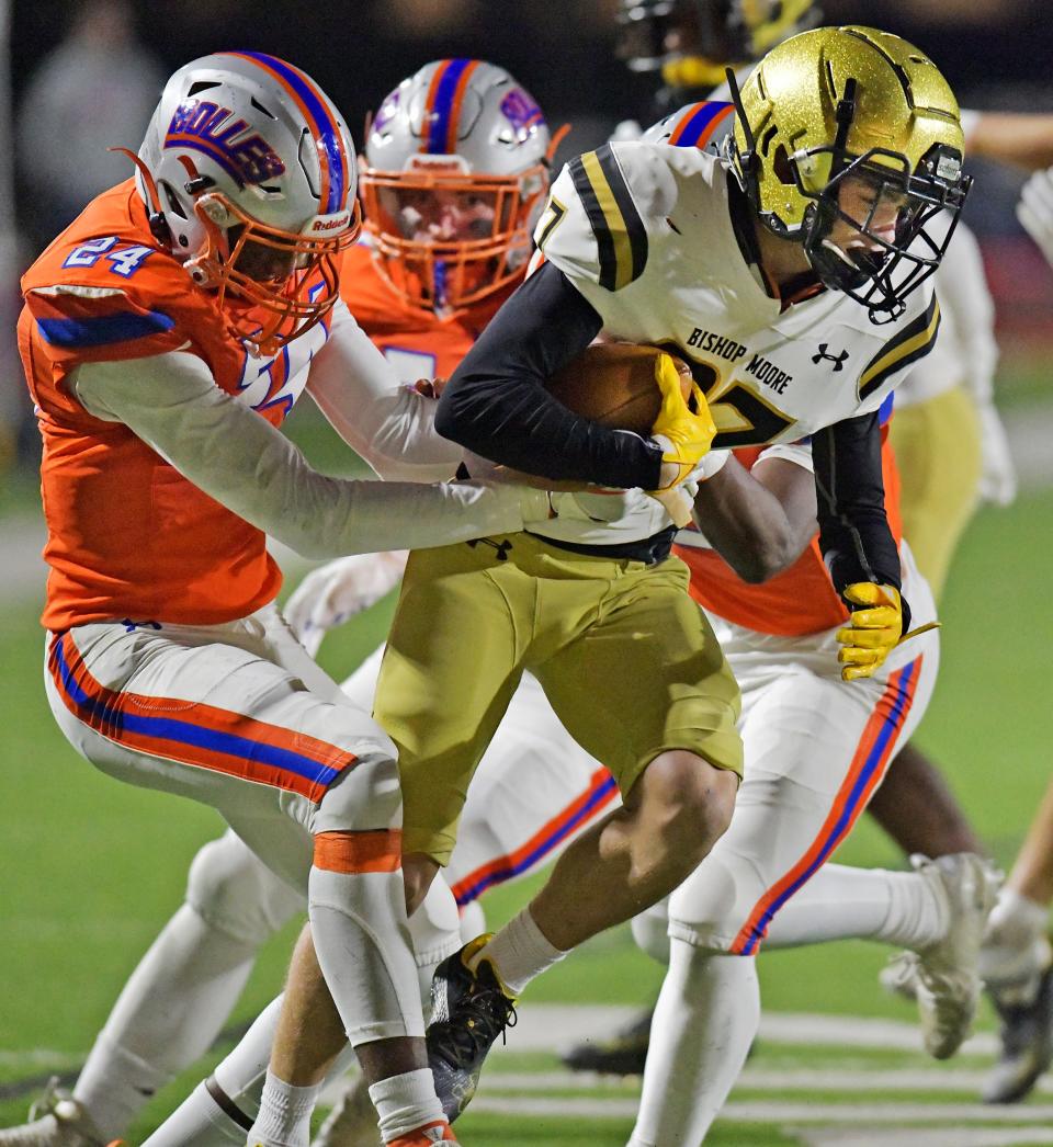 Bolles safety Simeon Caldwell (24) works to bring down Bishop Moore's Jaxson Anderson in the teams' 2022 playoff meeting.