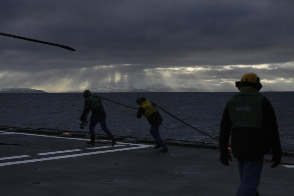 Mechanics prepare an helicopter for take-off aboard the French navy frigate Normandie during a patrol in a Norwegian fjord, north of the Arctic circle, Thursday March 7, 2024. The French frigate is part of a NATO force conducting exercises in the seas, north of Norway, codenamed Steadfast Defender, which are the largest conducted by the 31 nation military alliance since the cold war.(AP Photo/Thibault Camus)