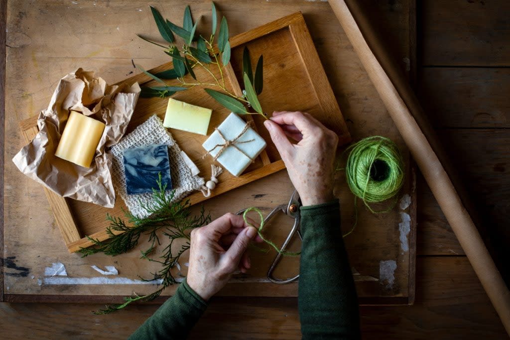 A person makes homemade soap.