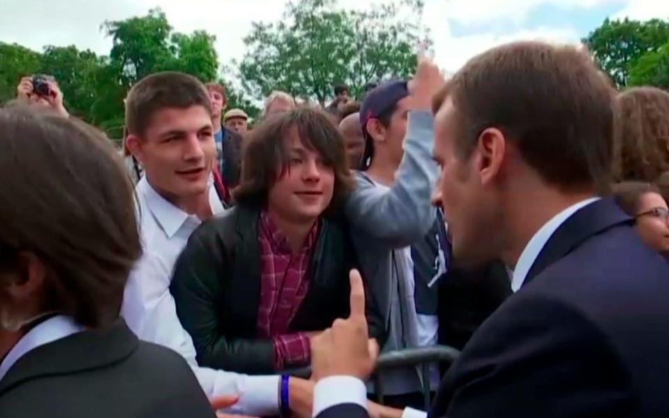 French President Emmanuel Macron speaks with the teenage boy in Paris - TF1