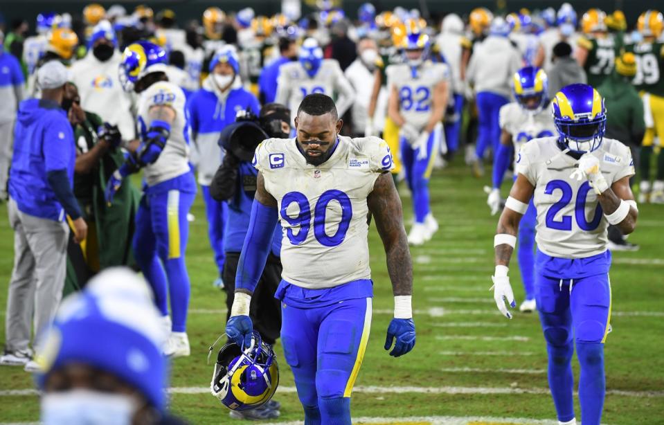 Rams defensive lineman Michael Brockers (90) and cornerback Jalen Ramsey (20) walk off the field after a loss to the Packers.